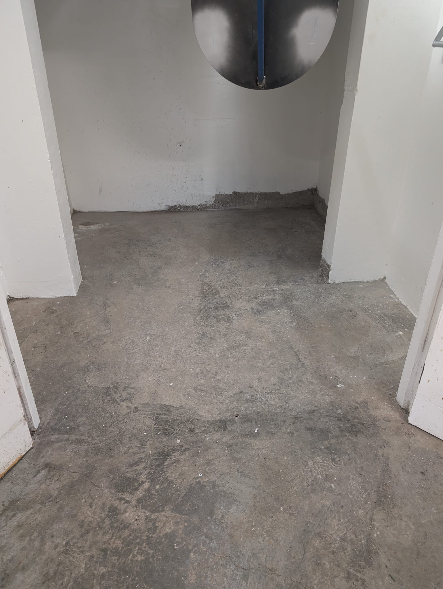 Before: stained, bare concrete bin room floor at Edgewater Gardens on the Gold Coast