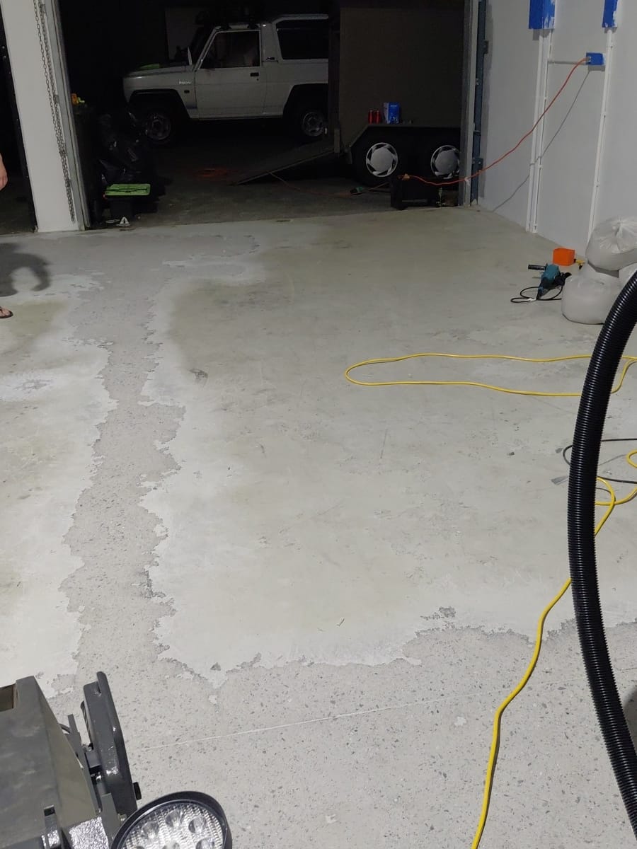 Before: failed, badly-done old epoxy being stripped off a Gold Coast garage floor